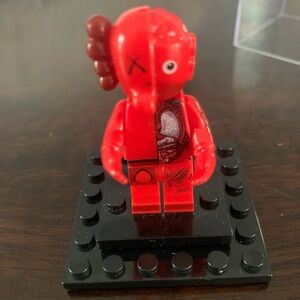 Kaws Toy Figure in red w display case